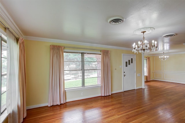 2000 Standifer St, Fort Worth, TX 76164 - foyer entrance with a chandelier, crown molding, visible vents, and wood finished floors