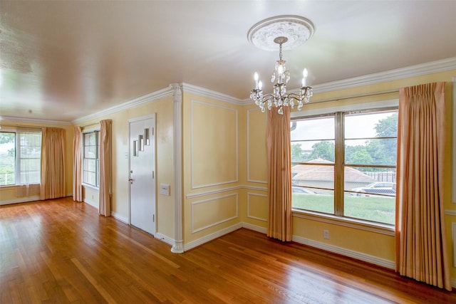 2000 Standifer St, Fort Worth, TX 76164 - spare room with crown molding, a notable chandelier, baseboards, and wood finished floors