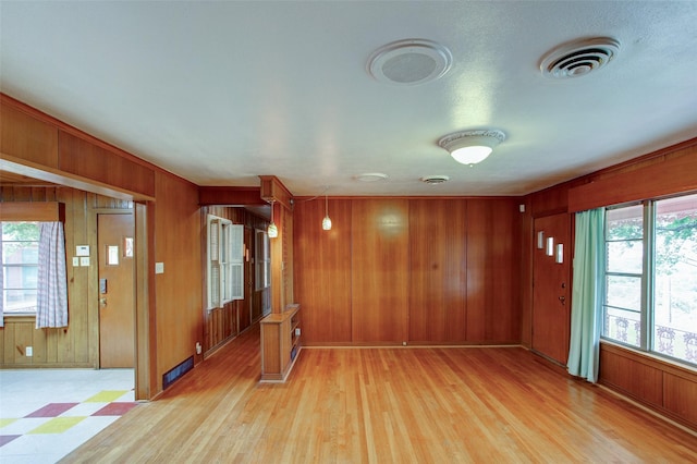 2000 Standifer St, Fort Worth, TX 76164 - spare room featuring wood walls, visible vents, and light wood-style floors