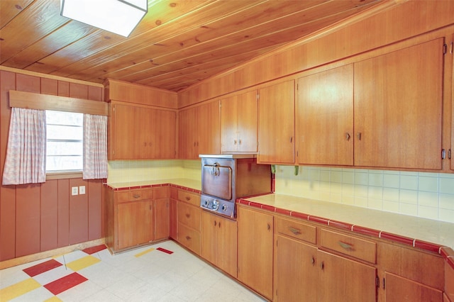 2000 Standifer St, Fort Worth, TX 76164 - kitchen with light flooring, tile counters, wooden ceiling, decorative backsplash, and a skylight