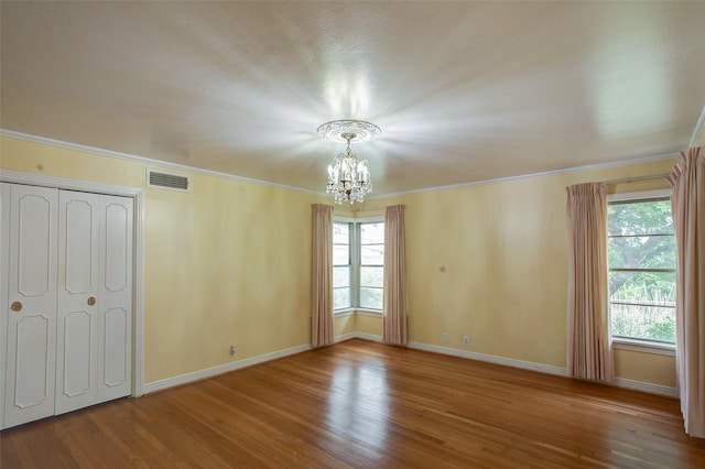 2000 Standifer St, Fort Worth, TX 76164 - unfurnished bedroom with a notable chandelier, baseboards, visible vents, and wood finished floors