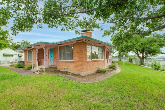 2000 Standifer St, Fort Worth, TX 76164 - bungalow-style home featuring a chimney, a front yard, brick siding, and fence