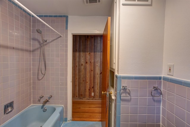 2000 Standifer St, Fort Worth, TX 76164 - full bath featuring a wainscoted wall, shower / tub combination, tile walls, and visible vents