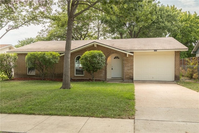 single story home with an attached garage, a front lawn, brick siding, and driveway
