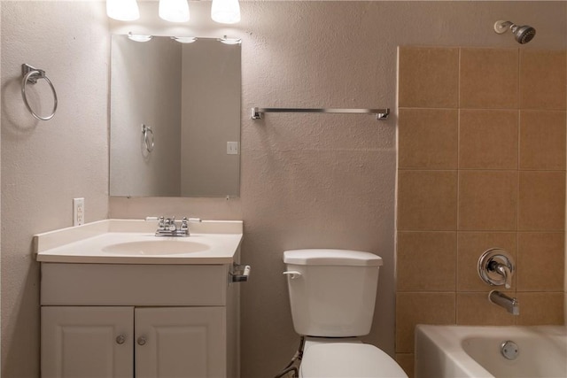bathroom with toilet, vanity, and shower / washtub combination