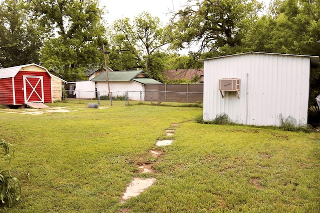 view of yard with a storage shed, an outdoor structure, and fence
