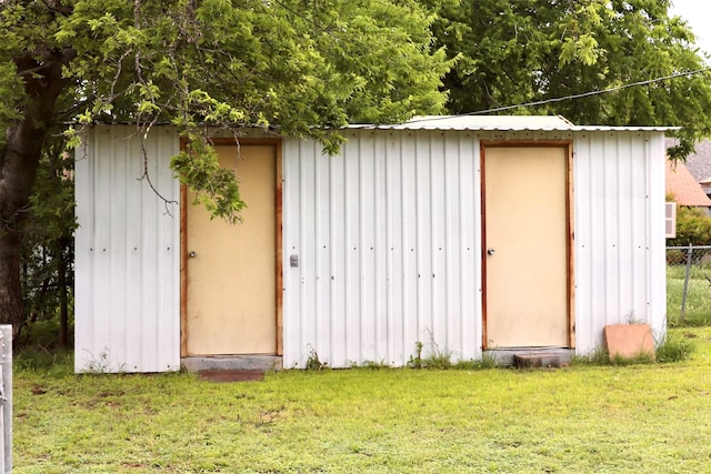 view of shed featuring fence