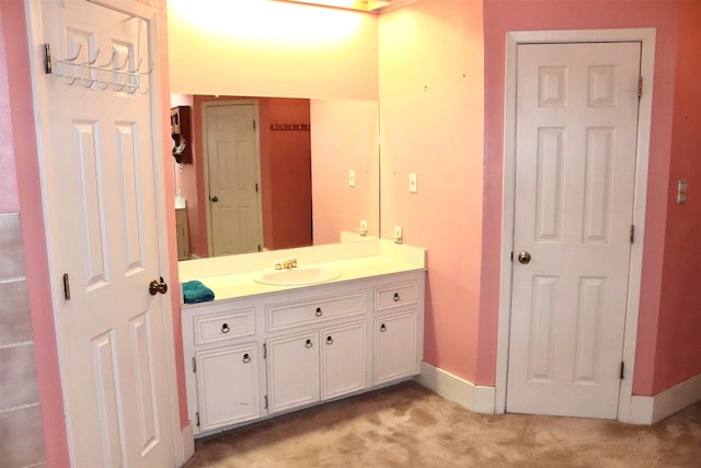 bathroom featuring baseboards and vanity