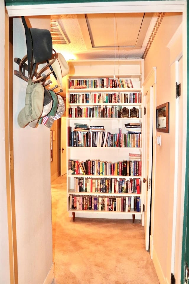 hall with baseboards and carpet floors