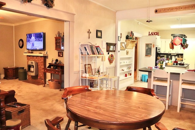 dining area with light colored carpet and crown molding