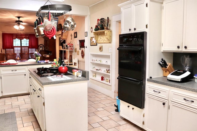 kitchen featuring white cabinetry, a center island, a ceiling fan, and black appliances