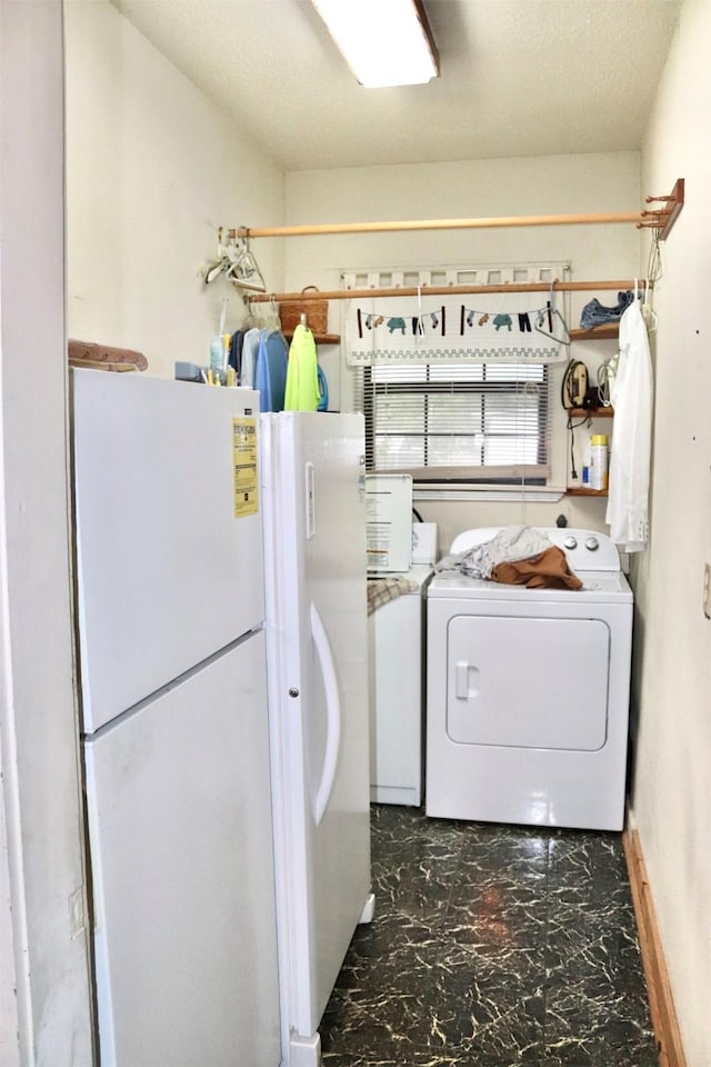 clothes washing area featuring washer / dryer, laundry area, and marble finish floor