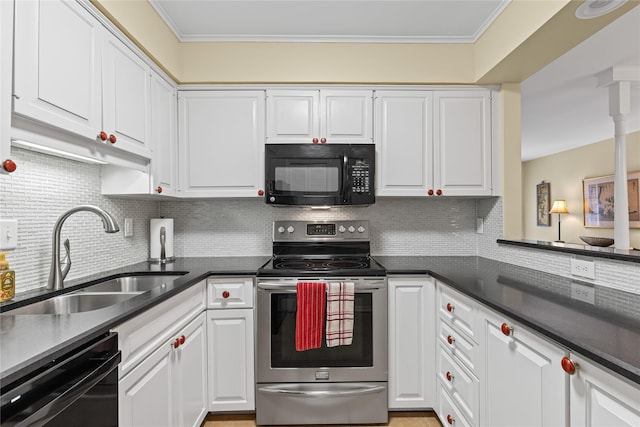 kitchen with dark countertops, white cabinetry, black appliances, and a sink