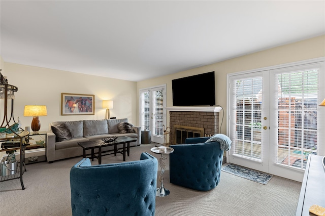 carpeted living area featuring a fireplace and french doors