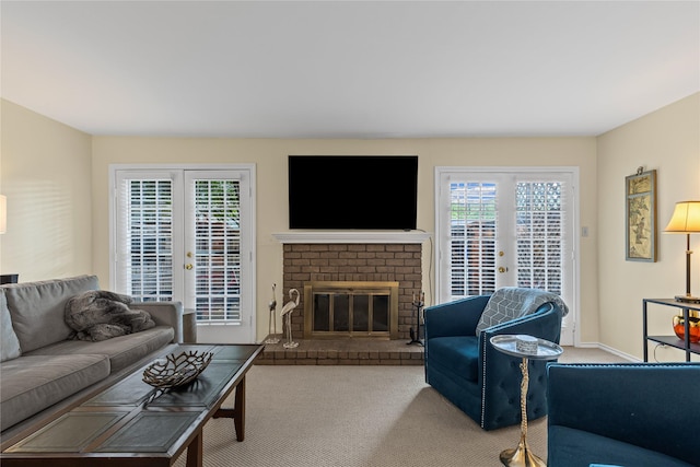 carpeted living area with french doors and a fireplace