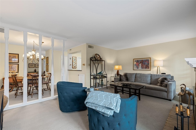 living area featuring carpet flooring, a chandelier, and visible vents