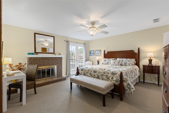 bedroom featuring carpet flooring, a ceiling fan, a fireplace, visible vents, and access to outside