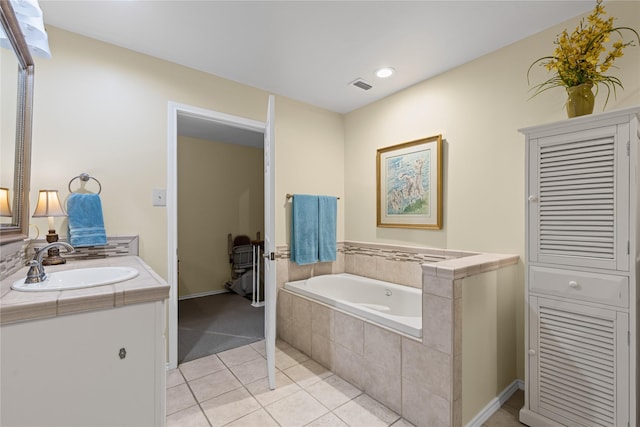 bathroom with a bath, visible vents, tile patterned flooring, baseboards, and vanity