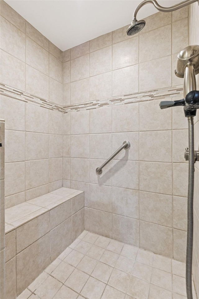 full bath featuring tiled shower