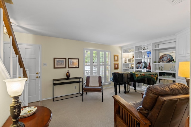 sitting room with carpet floors and built in features