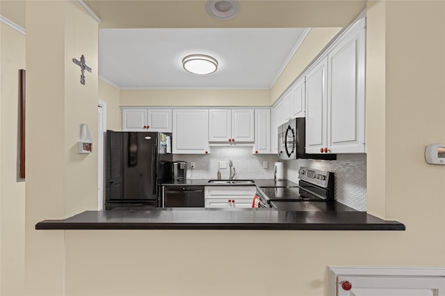 kitchen with black appliances, a peninsula, crown molding, and tasteful backsplash