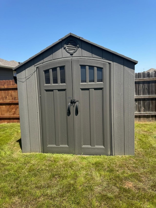 view of shed with fence