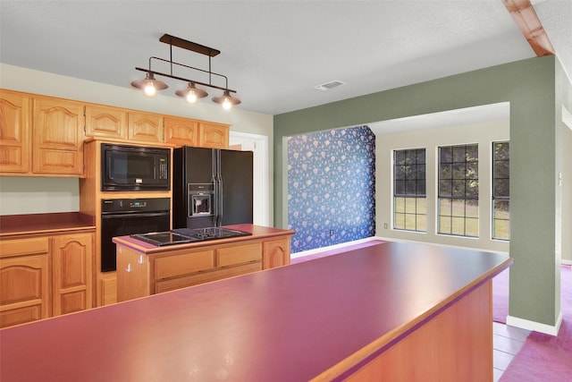 kitchen featuring light brown cabinets, visible vents, black appliances, a kitchen island, and light tile patterned flooring
