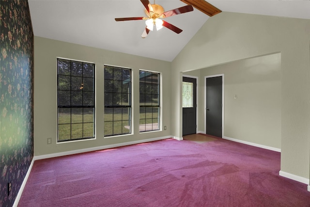 carpeted spare room featuring ceiling fan, beamed ceiling, baseboards, and high vaulted ceiling