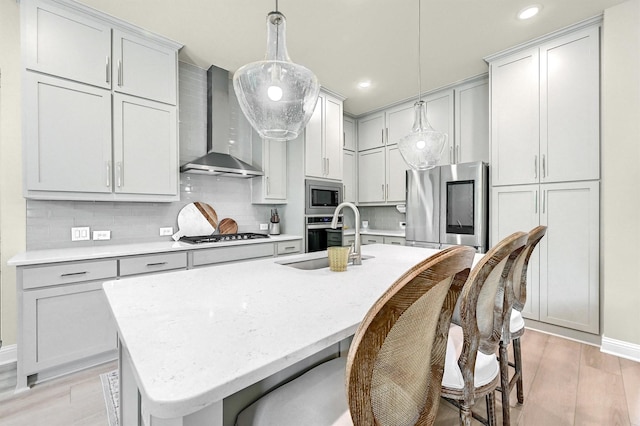 1504 Bearpath Way, Gunter, TX 75058 - kitchen featuring wall chimney exhaust hood, appliances with stainless steel finishes, backsplash, light wood finished floors, and recessed lighting