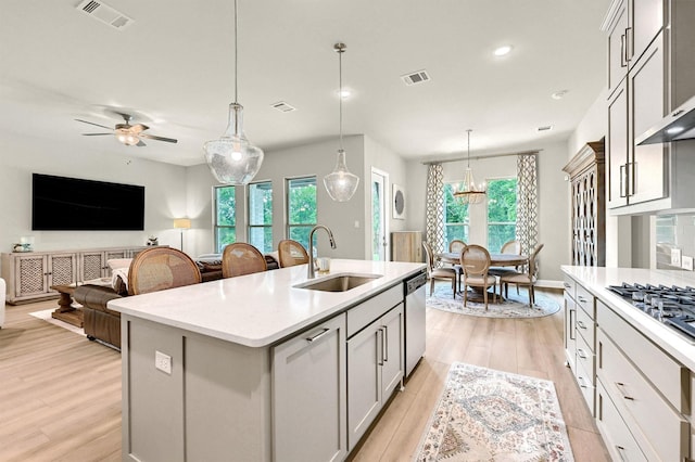 1504 Bearpath Way, Gunter, TX 75058 - kitchen with light wood-style flooring, a kitchen island with sink, range hood, gray cabinetry, and hanging light fixtures