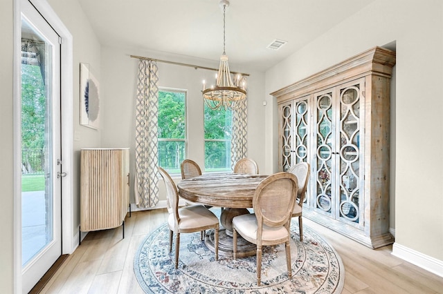 1504 Bearpath Way, Gunter, TX 75058 - dining area with a chandelier, healthy amount of natural light, light wood finished floors, and radiator heating unit