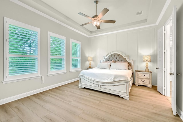 1504 Bearpath Way, Gunter, TX 75058 - bedroom with a tray ceiling, light wood-type flooring, and multiple windows
