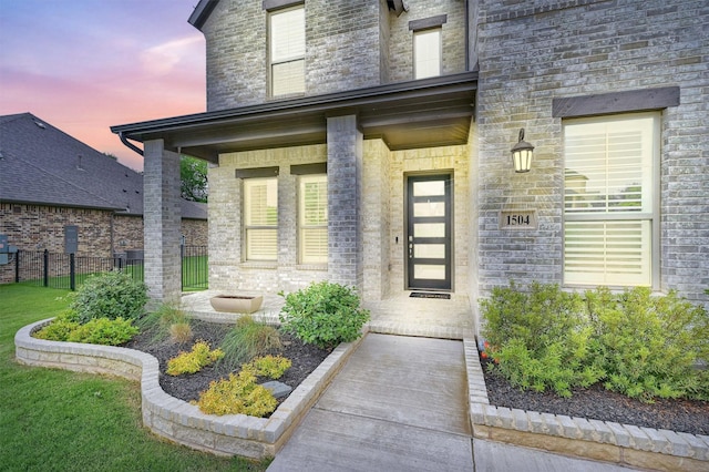 1504 Bearpath Way, Gunter, TX 75058 - exterior entry at dusk with a porch and stone siding