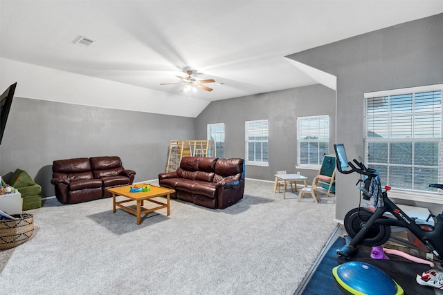 living area with carpet flooring, a ceiling fan, visible vents, baseboards, and lofted ceiling