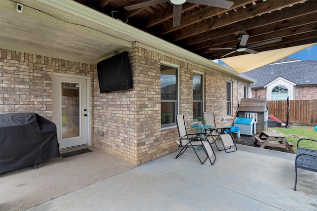 view of patio / terrace with area for grilling, fence, and ceiling fan