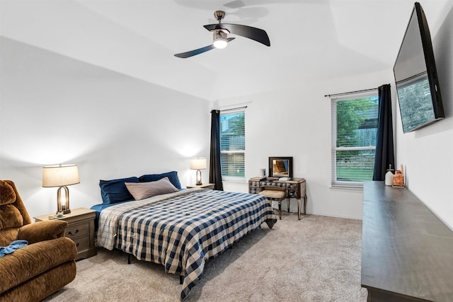 carpeted bedroom with ceiling fan and lofted ceiling