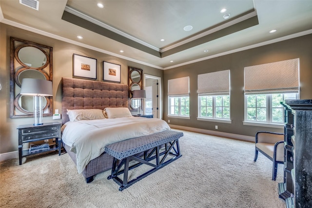 bedroom with a tray ceiling, carpet floors, baseboards, and visible vents