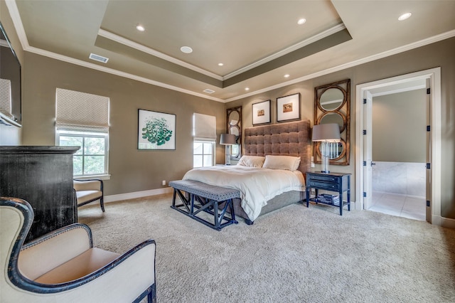 bedroom with baseboards, a tray ceiling, visible vents, and carpet floors