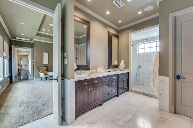 full bathroom featuring a stall shower, ornamental molding, visible vents, and a sink