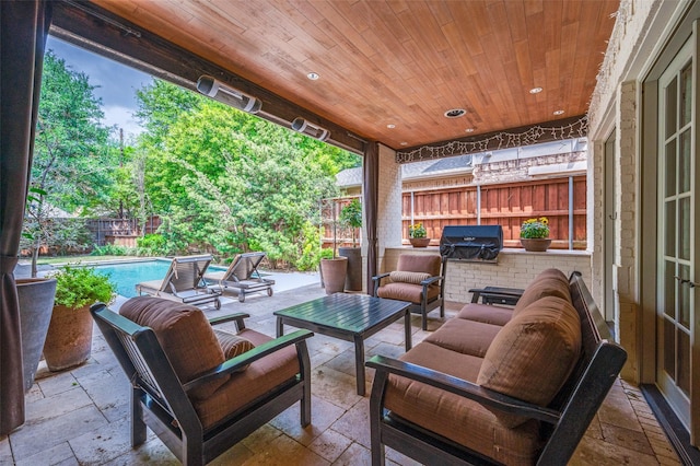 view of patio / terrace featuring a fenced backyard, area for grilling, outdoor lounge area, and an outdoor pool