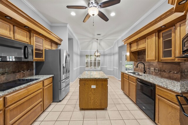 609 S Ruidoso Downs Dr, Robinson, TX 76706 - kitchen featuring a sink, brown cabinets, black appliances, decorative backsplash, and a center island