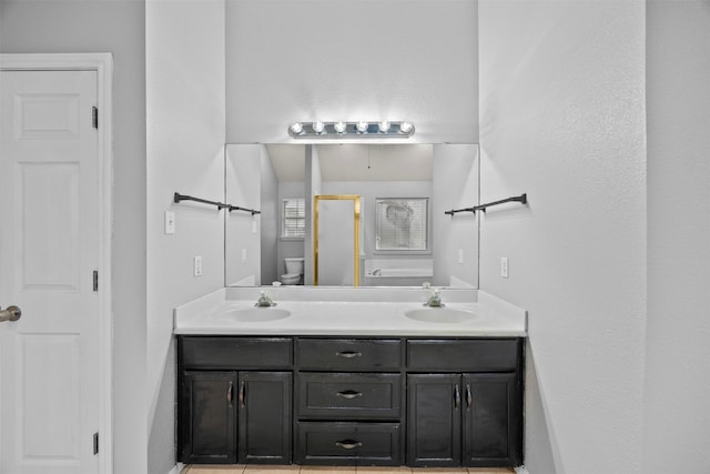 609 S Ruidoso Downs Dr, Robinson, TX 76706 - bathroom featuring double vanity, toilet, a shower with door, and a sink