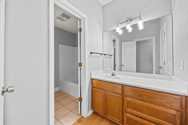 609 S Ruidoso Downs Dr, Robinson, TX 76706 - bathroom with tile patterned floors, visible vents, vanity, and shower / tub combination
