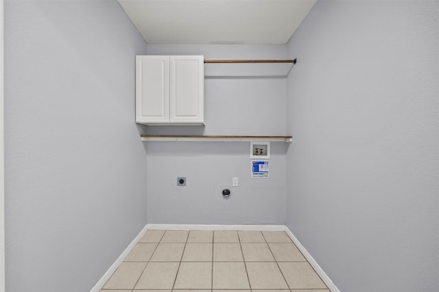 609 S Ruidoso Downs Dr, Robinson, TX 76706 - clothes washing area with cabinet space, hookup for an electric dryer, light tile patterned flooring, baseboards, and hookup for a washing machine
