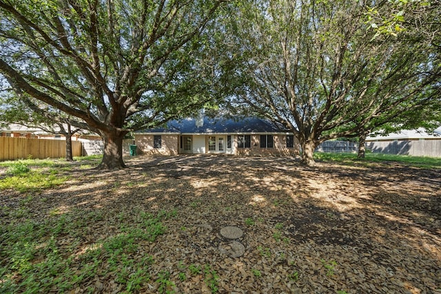 609 S Ruidoso Downs Dr, Robinson, TX 76706 - back of house featuring french doors and a fenced backyard