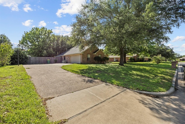 609 S Ruidoso Downs Dr, Robinson, TX 76706 - view of front of home featuring a garage, fence, aphalt driveway, a front yard, and brick siding