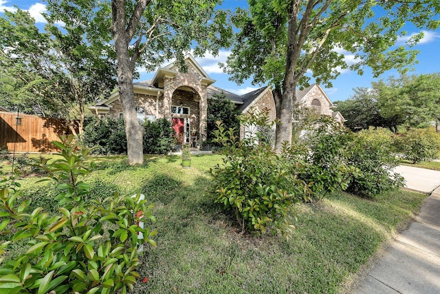 10110 Andre Dr, Irving, TX 75063 - obstructed view of property with stone siding, brick siding, and fence