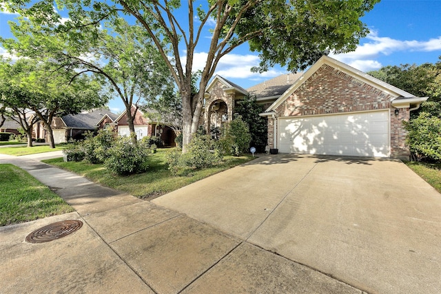 10110 Andre Dr, Irving, TX 75063 - view of front of home with concrete driveway, brick siding, and a garage