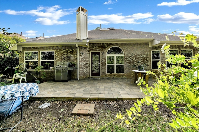 10110 Andre Dr, Irving, TX 75063 - rear view of property featuring a shingled roof, a patio, and brick siding