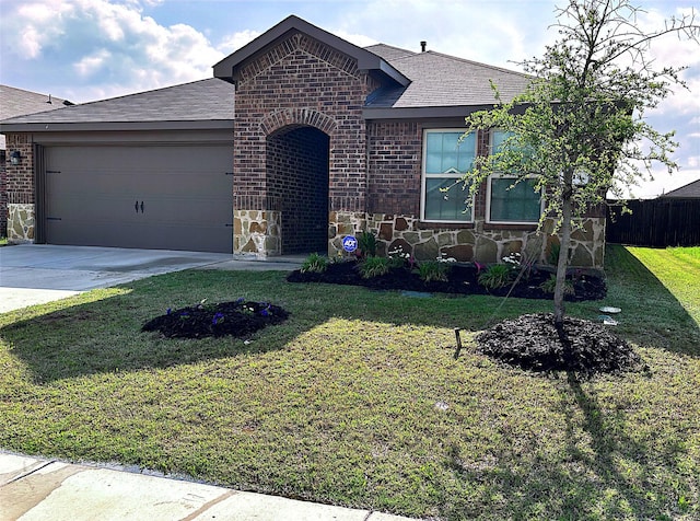 ranch-style home featuring stone siding, fence, a shingled roof, a front lawn, and driveway